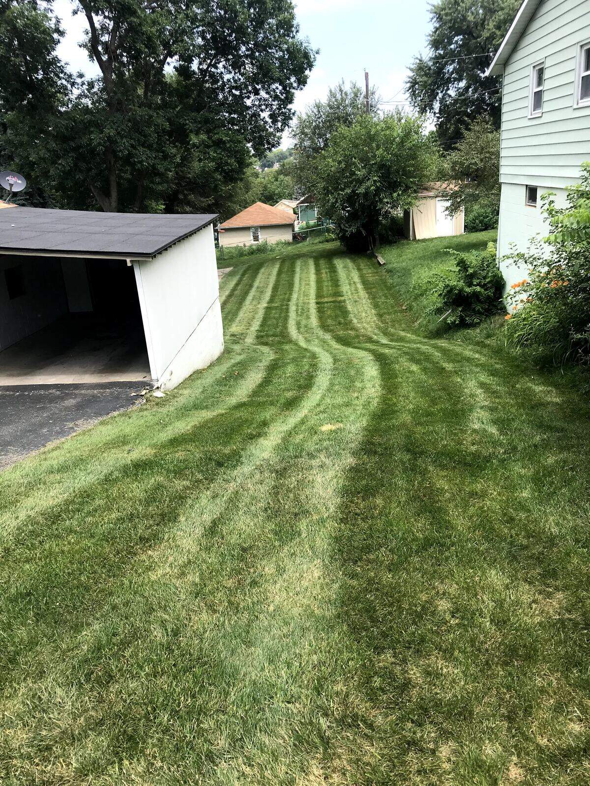 Backyard hill mowing in Bellevue, NE by Picasso Lawn Care